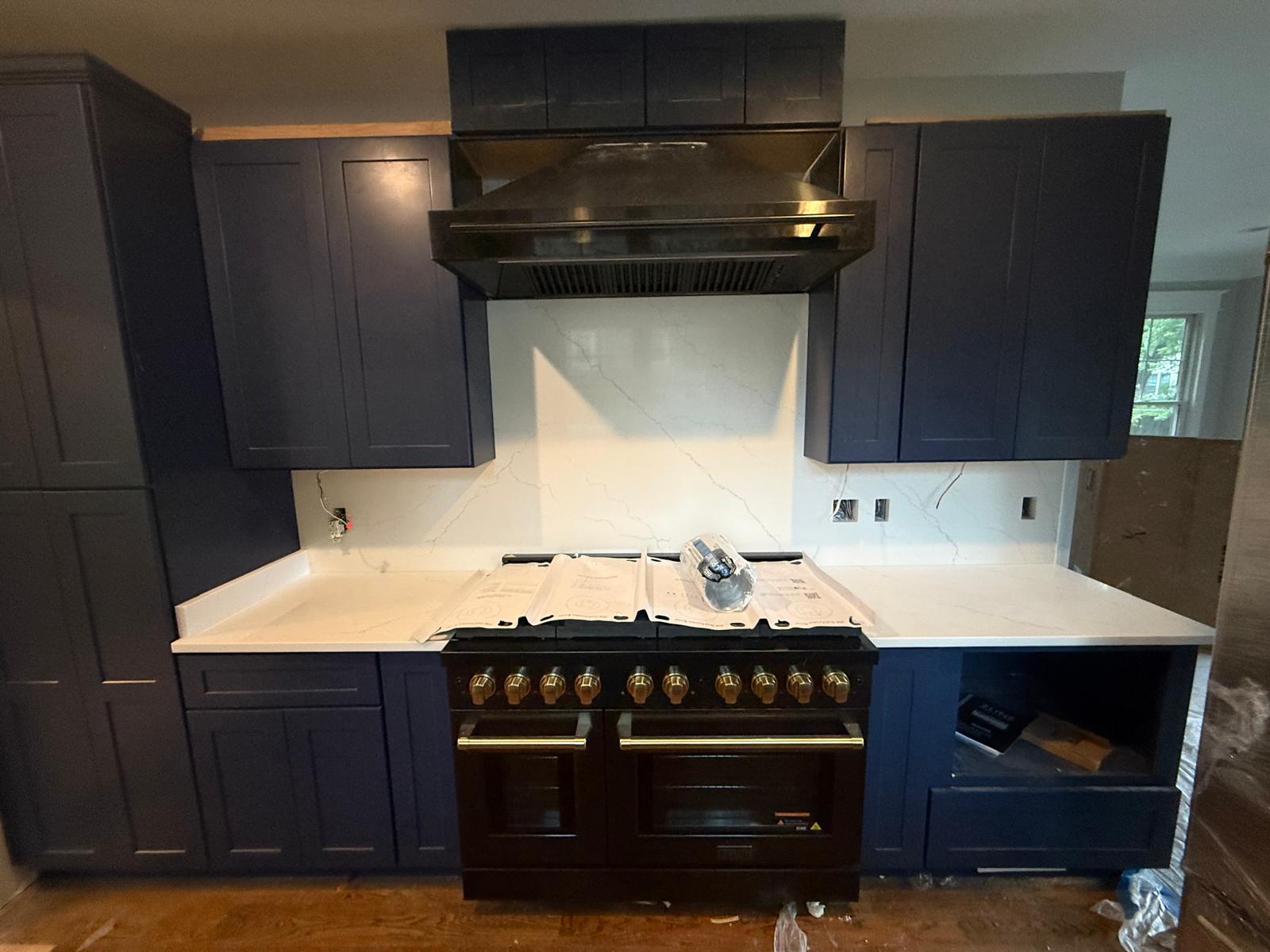 Navy blue cabinets and white quartz countertops kitchen installation